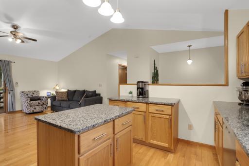 Updated kitchen with stainless steel appliances, granite counters and tile backsplash