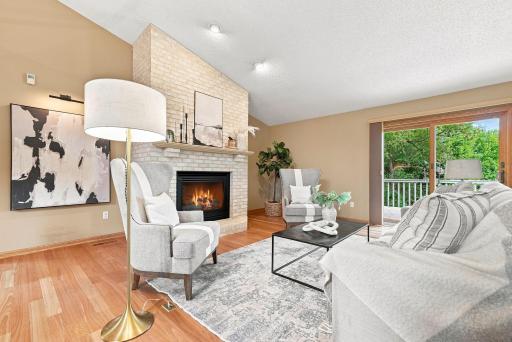 Light-filled living spaces, warm hardwood floors, and a central fireplace bring everyday comfort and character together.