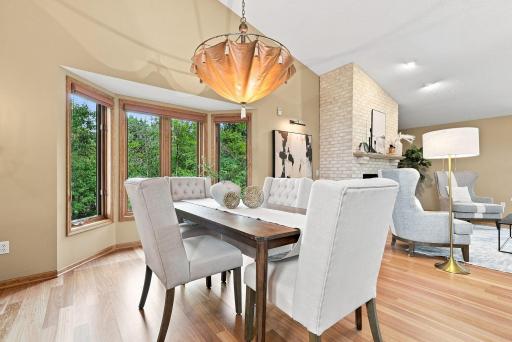 An inviting dining room with beautiful volume, warm wood floors, and an easy connection to the living spaces around it.