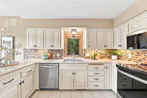 Bright cabinetry, generous workspace, and an efficient layout make this kitchen ready for everything from morning coffee to dinner with friends.
