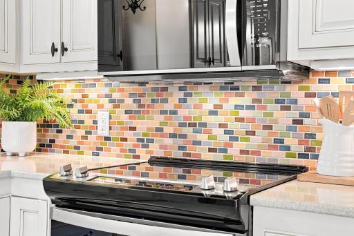 A colorful backsplash gives the kitchen a distinctive touch while keeping the space warm and approachable.