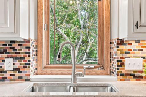 Even the kitchen sink comes with a view, bringing the greenery outside into the everyday routine.