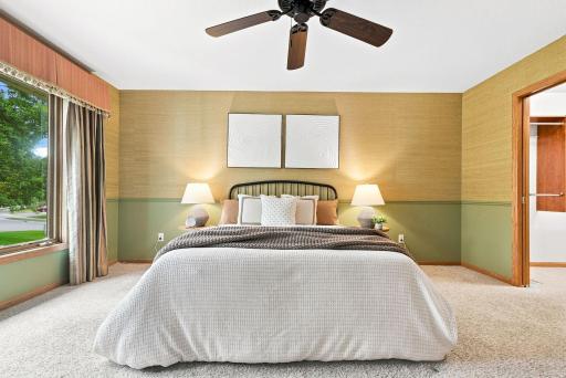 A spacious primary bedroom with peaceful views, warm finishes, and room to truly make the space your own.