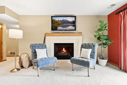 A second fireplace brings warmth and character to the lower-level family room.