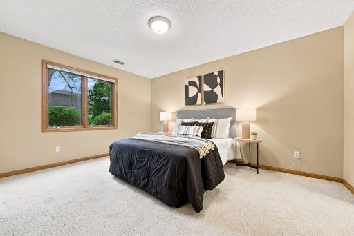 A comfortable lower-level bedroom provides privacy for guests or added everyday flexibility.