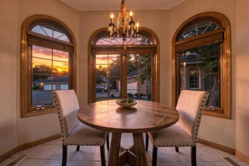 Dinner comes with a view here. Arched windows frame the evening sky and fill this intimate dining space with beautiful natural color.