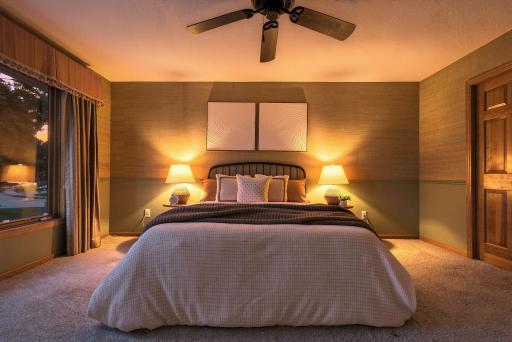 A calm end to the day, with a spacious bedroom, soft lighting, and a peaceful atmosphere designed for rest.