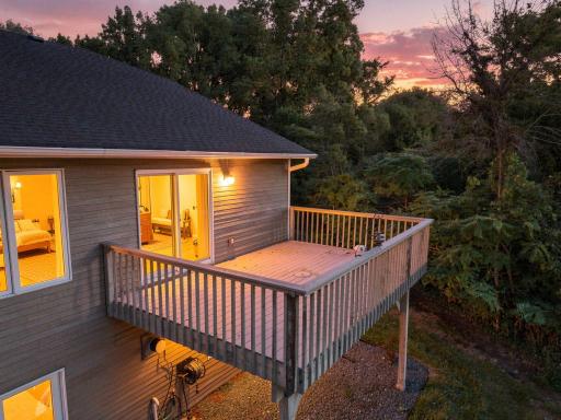 An evening setting worth lingering over. The elevated deck looks into the mature trees while the sunset adds the perfect finishing touch.