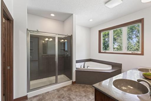 Primary bathroom with shower, tub, double sinks and walk-in closet