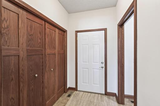 Garage entrance with laundry room and large storage closet