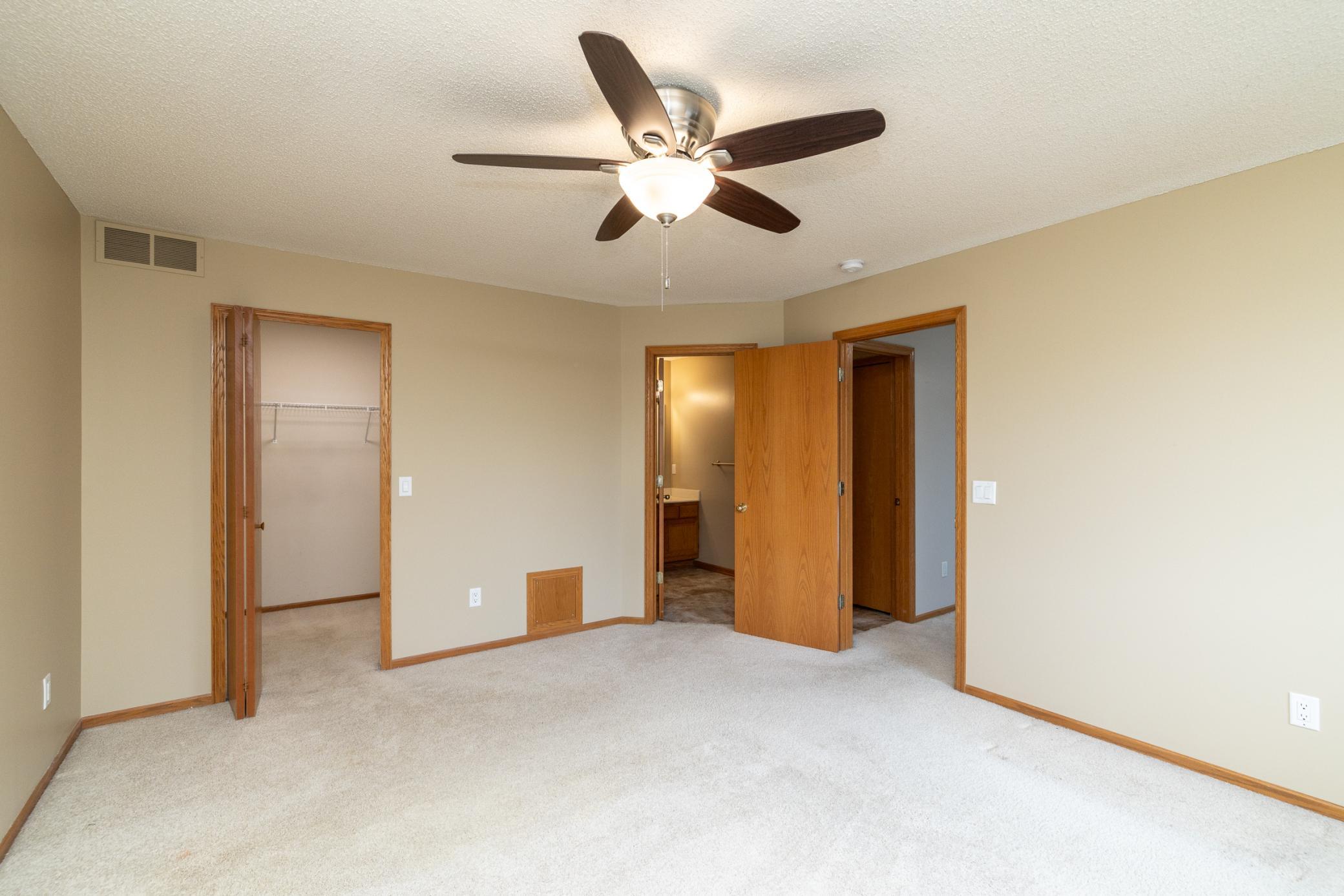 Spacious primary bedroom with direct access to bathroom