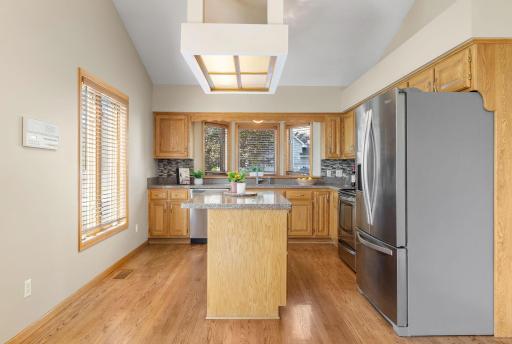 Updated with quartz countertops, backsplash, stainless appliances and refinished hardwood floors.