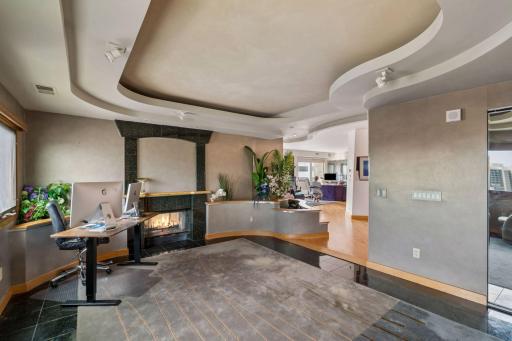 Office/den space with wood burning fireplace.