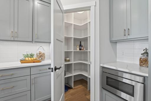 Walk-in pantry with solid adjustable shelves.
