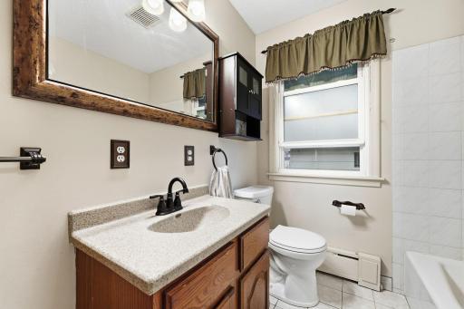 Bath that was updated. Full bath with tub shower combination. Frosted glass windows for light and privacy.
