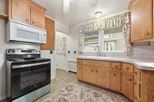 The kitchen door opens to the sidewalk that leads to the garage making it easy to bring in groceries. Opposite the exterior door is the door to the lower level.