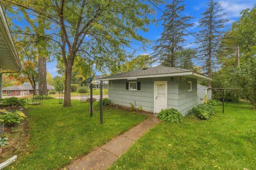 Side door to garage and sidewalk to make it easy to access the car. Mature hostas suround the garage and home. Storage shed for gardening tools and yard maintenance.