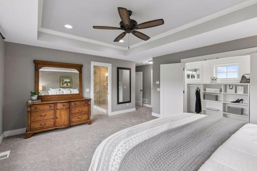 Alternate view of Primary Suite showing access to private bath & walk-in closet.