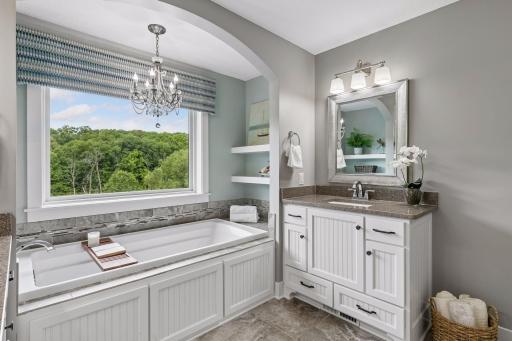 Serenity in this primary ensuite including dual vanities, heated flooring, a soaker tub & an extra large walk-in shower!