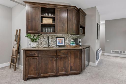 Wet bar complete with sink, beverage cooler & microwave making entertaining easy & fun!