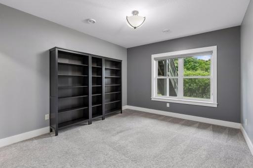 The 5th bedroom is located in the lower level. Generously sized, it could be a wonderful home office, too!
