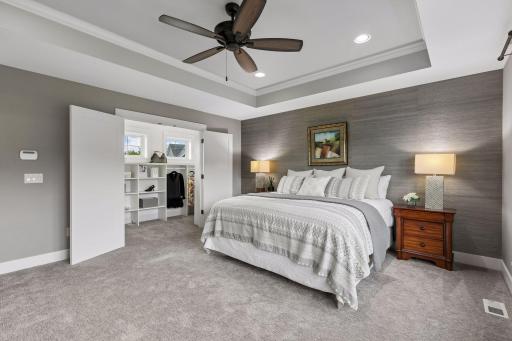 Luxurious Primary Suite offering a tray ceiling complemented by a spacious walk-in closet!