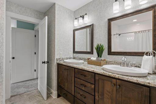 Elevated decor in this Jack and Jill full bath with convenient dual vanity & tasteful finishes!