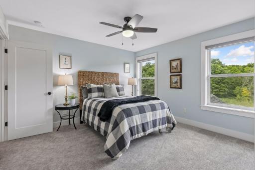 Bedroom 3 on the upper level towards the back of the home offers tranquil views!