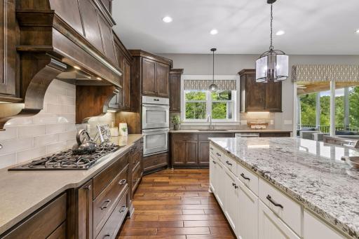 The kitchen island includes a stunning quartz counter and the perimeter includes a timeless granite.