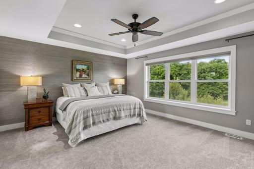 Private wooded views in this primary suite next to a spa inspired full bath!