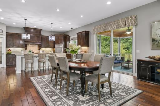 This informal dining space with the screened porch off to the right is the perfect place to host your family & friends!