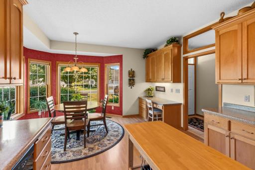 Desk in corner of kitchen and backs up to foyer
