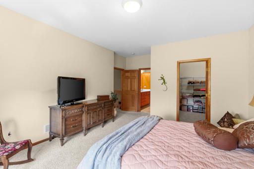 Primary bedroom with view to good size walk-in closet and bath
