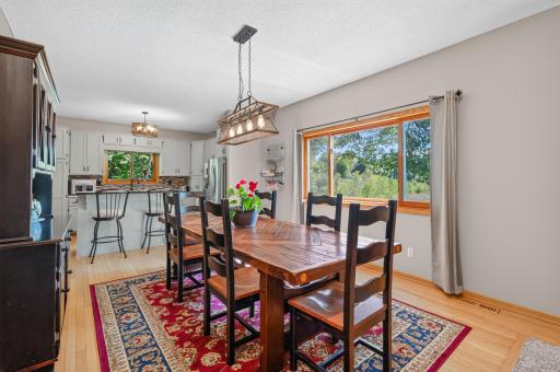 Bright, spacious living room with hardwood floors and sliding doors leading to the deck and private backyard setting.