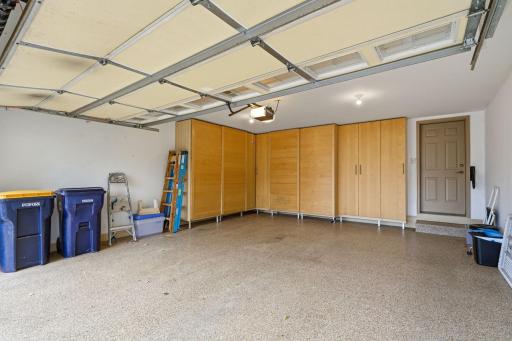 Garage with finished floors & cabinet storage