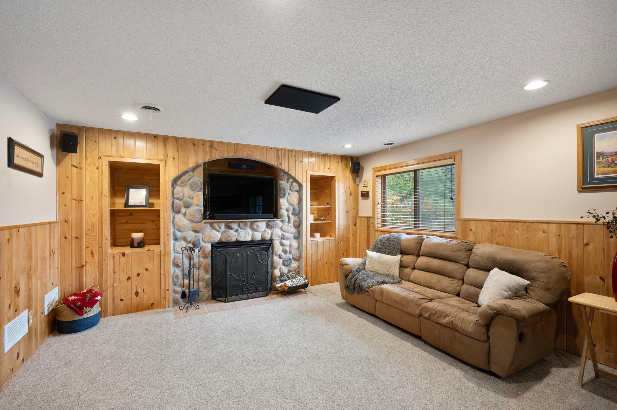 Family Room with gas fireplace, walk out to patio and flat 3.34 acre backyard with large Quonset Hut with Car Lift