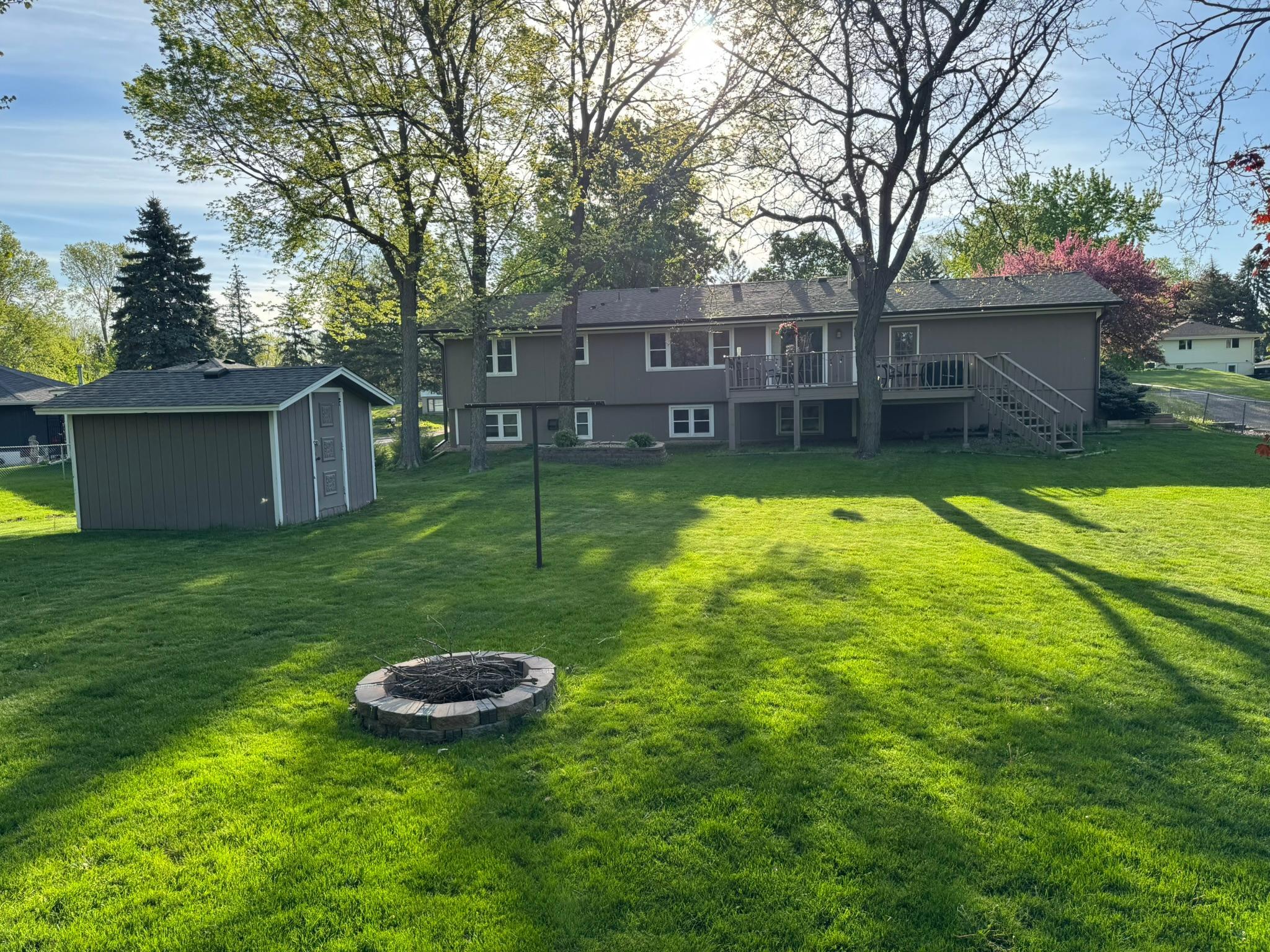 Temp Photo of exterior with fire-pit, multi-level deck with stairs to yard and Shed (Back of home)