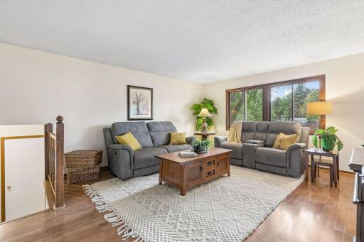 At the heart of the main level, you'll find the living room, dining area, and kitchen seamlessly connected, with a walkout to the deck that creates the perfect setting for entertaining guests, grilling, and enjoying time outdoors with pets.