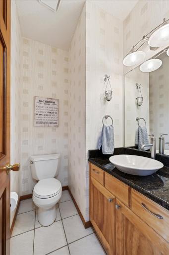 The main-level half bath adds convenience for everyday living and entertaining.