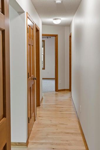 Hallway leading to linen closet, full bathroom, and 2 more main floor bedrooms.