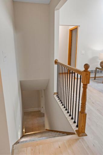Great room, bar, 4th bedroom, and office to the right as you head downstairs. Spacious and clean storage/utility room to the left.