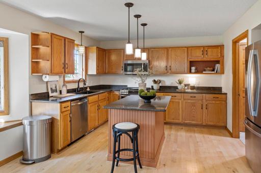 Open kitchen with plenty of storage, access to laundry room and garage on the other side of the refrigerator.