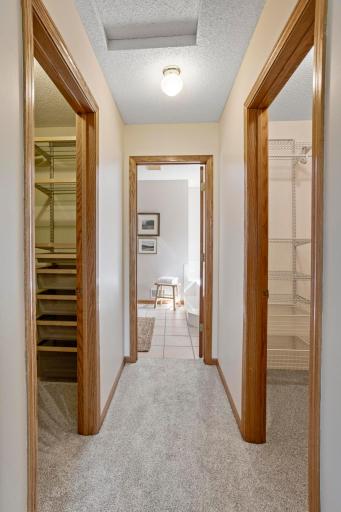 Mirrored closets with installed organizers as you head to the ensuite bathroom.