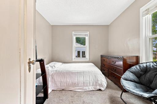 Cozy and comfortable bedroom with natural light, offering a peaceful space to relax and recharge