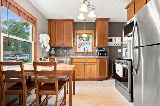 Bright eat-in kitchen with new stainless steel appliances, abundant cabinetry, and a welcoming space for everyday meals and gathering.