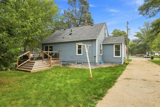 Spacious backyard with a large deck, lush green lawn, and plenty of room for outdoor entertaining and relaxation.