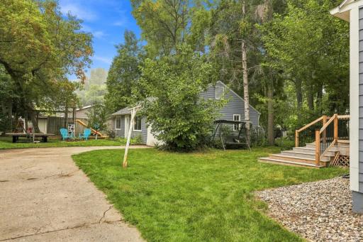 Spacious backyard with mature trees, open green space, and room to relax, play, or entertain.