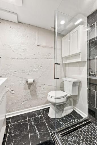 Beautifully updated bathroom featuring a sleek walk-in shower, modern finishes, and a fresh contemporary design.