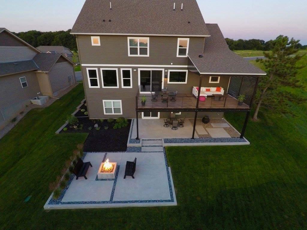 Aerial view captures the full backyard experience—large deck, covered patio, tiered concrete terrace and natural-gas firepit. This picture was taken before the area was fully developed.