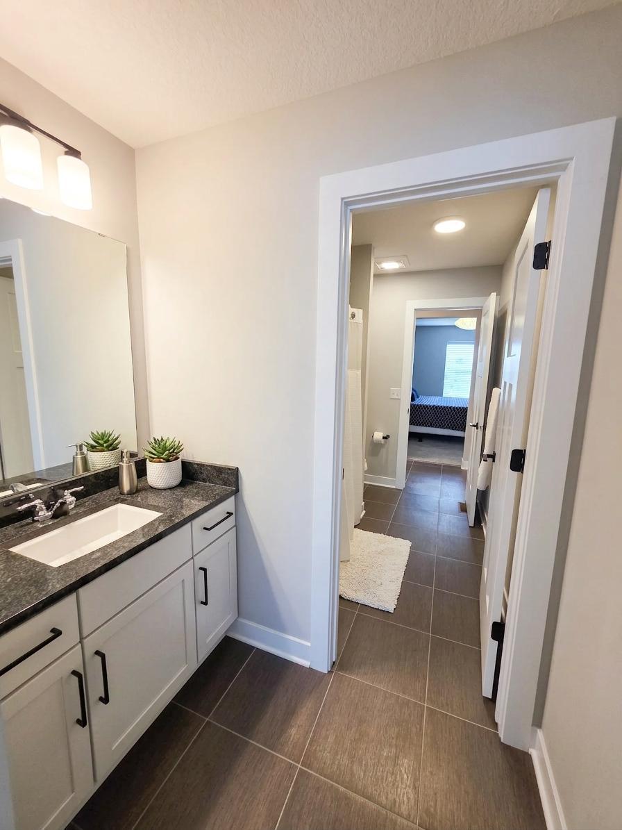 Second private vanity area completes the thoughtfully designed Jack-and-Jill bath.